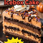 Layered orange and white icebox cake decorated with chocolate spider webs and small candy pumpkins on a platter.