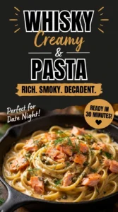 Creamy pasta tossed in a whisky sauce with pieces of smoked salmon, garnished with fresh parsley in a white bowl.